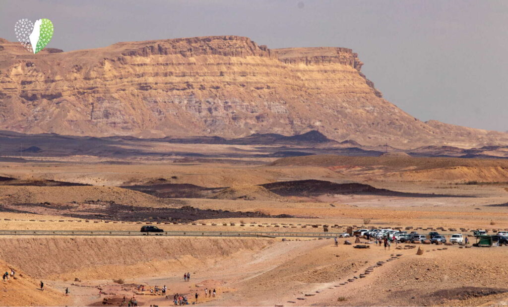 Sunset casting a golden hue over the rugged desert terrain