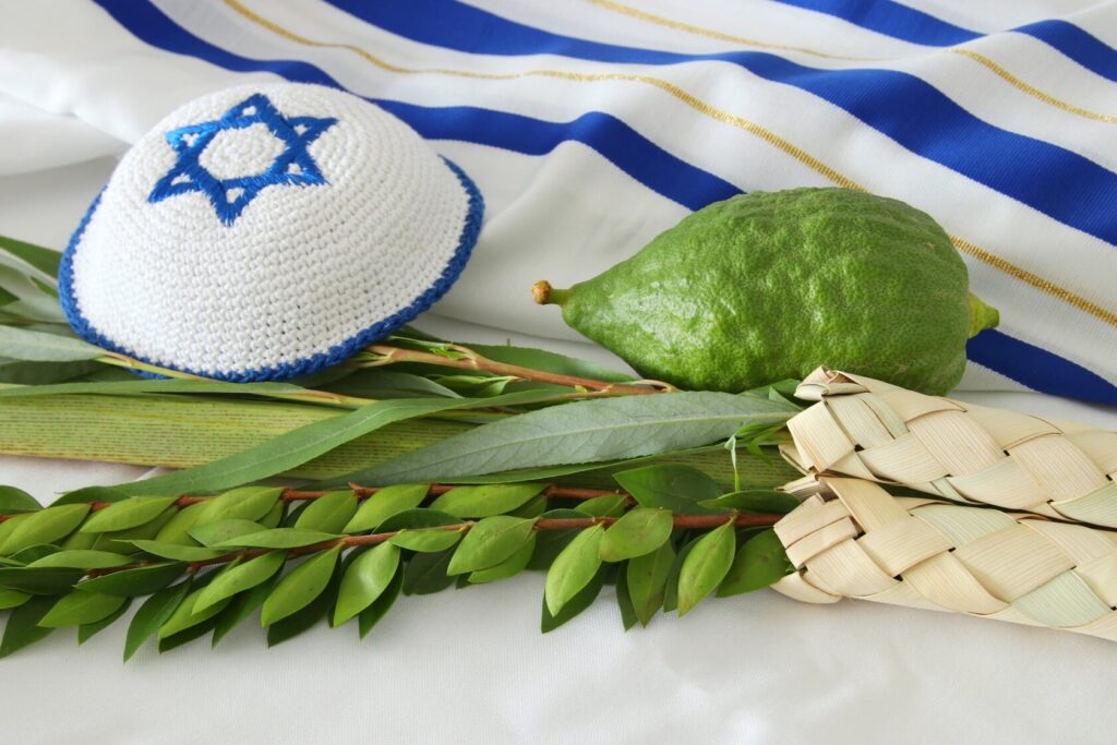 Traditional Sukkot meal with challah, fruits, and wine