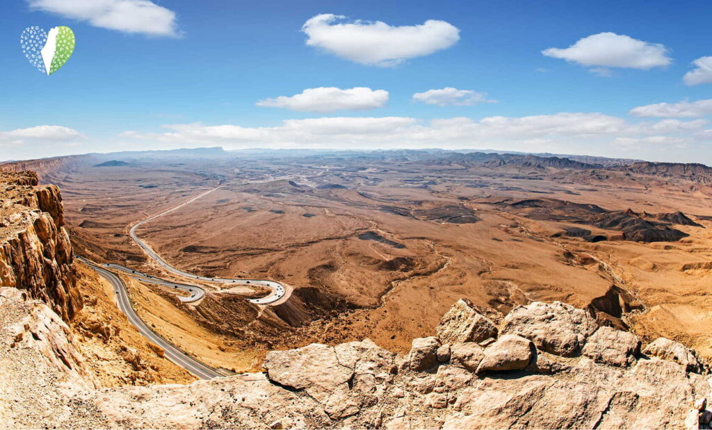 A lone factory stands resilient in the vast desert landscape