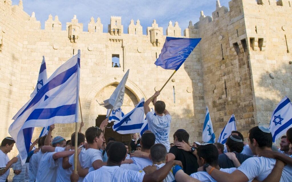 Children waving Israeli flags in a parade