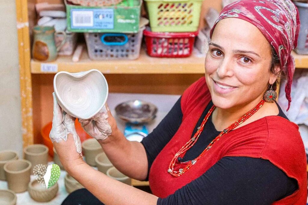 Batya Erdstein shaping a ceramic piece in her studio